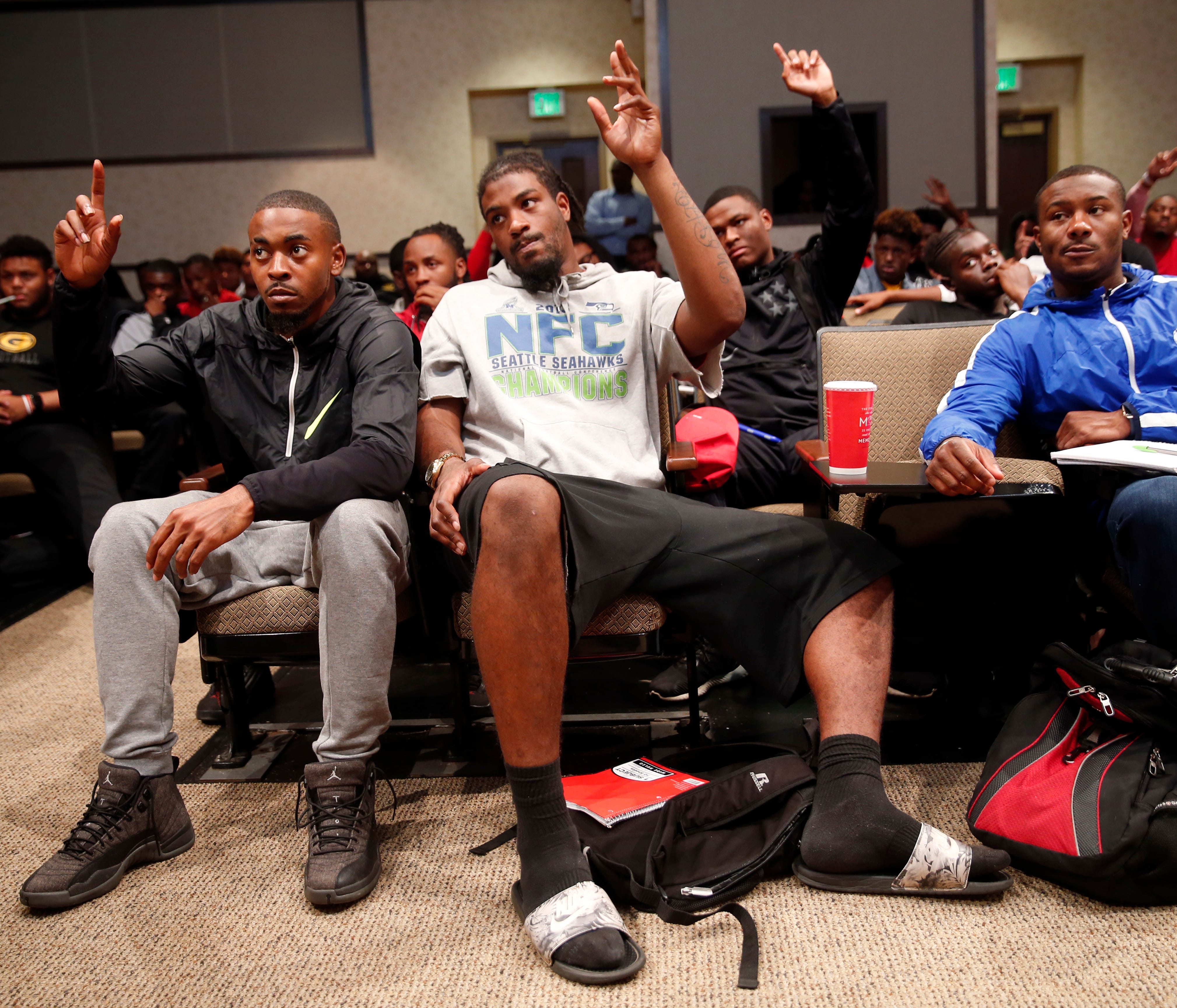 In this Monday, Nov. 13, 2017 photo, Devante Kincade, left, quarterback for the Grambling's NCAA college football game college football team, participates in a team meeting at the university in Grambling, La. Kincade, who played two seasons at Missis