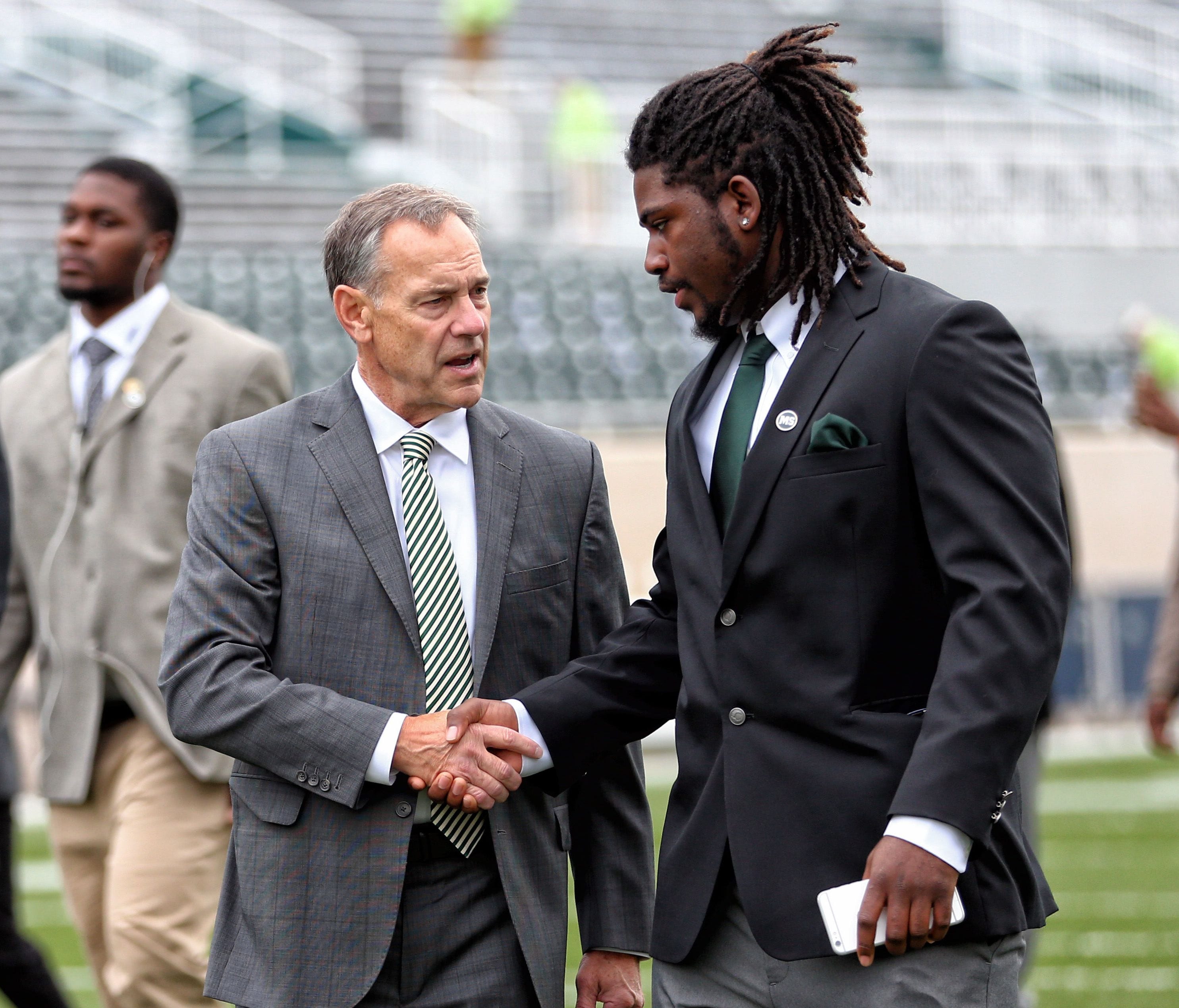 Michigan State head coach Mark Dantonio talks with former Spartans defensive end Auston Robertson before last season's game against Michigan. Robertson, facing sexual assault charges, was kicked out of the program in April.