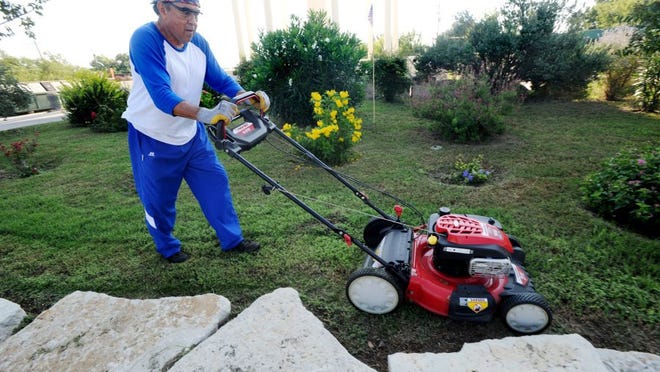 Nellie Doneva/Reporter-News Martin Garcia mows a garden he created and maintains by the recycling center on Buffalo Gap Road. Garcia is the longest-sitting board member of Keep Abilene Beautiful.