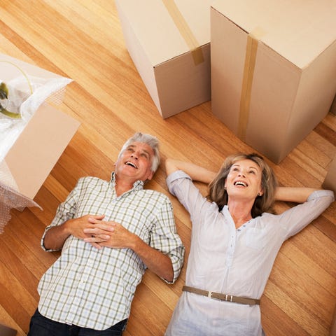 Senior couple surrounded by moving boxes.