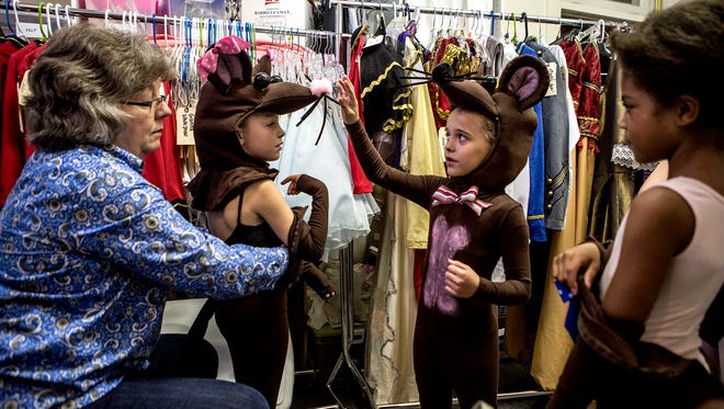 Suzanne Ascchenbeck has been busy making new mouse costumes for the Central Ohio Youth Ballet's performance of the Nutcracker. Young ballerinas Emma Federer, Bella Jump and Jacie Johnson were all excitedly trying on their new individualized costumes. 