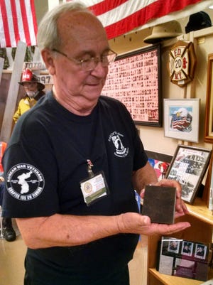 Ralph Santillo, president of the Southwest Florida Military Museum, shows a steel piece from the World Trade Center towers in New York City. His organization, Invest In America's Veterans, is key in providing help for Cape Coral veterans.