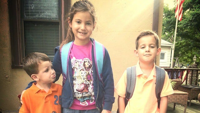 Second-grader Natalee and kindergartner John (right) get ready for school in Brooklawn while brother Ryan, 3, gets ready to miss them.