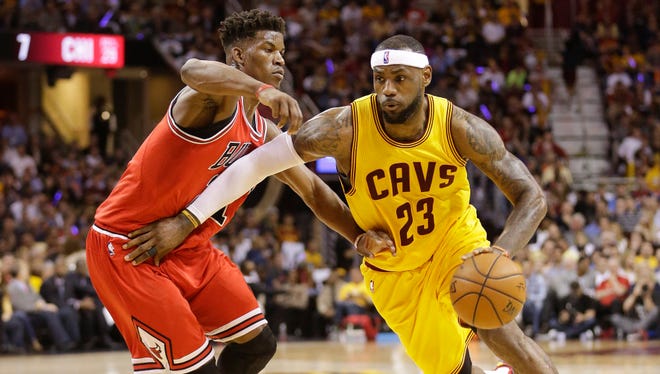 Cleveland Cavaliers forward LeBron James (23) drives against Chicago Bulls guard Jimmy Butler (21) during the first half of Game 2 in a second-round NBA basketball playoff series Wednesday, May 6, 2015, in Cleveland. (AP Photo/Tony Dejak) ORG XMIT: OHJJ119
