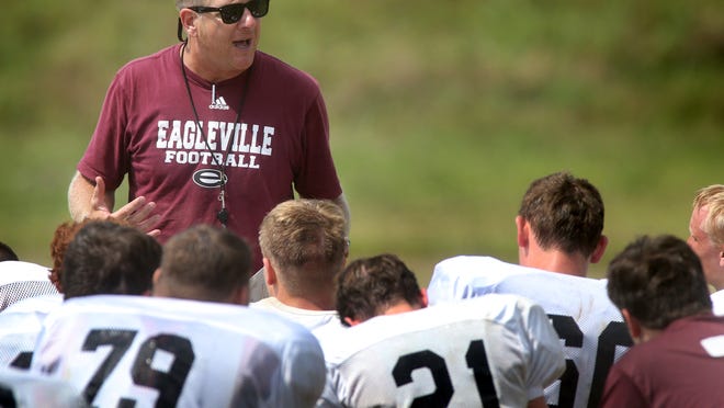 Eagleville head coach Steve Carson talks with the football team after practice at the school, on July 22, 2014.
