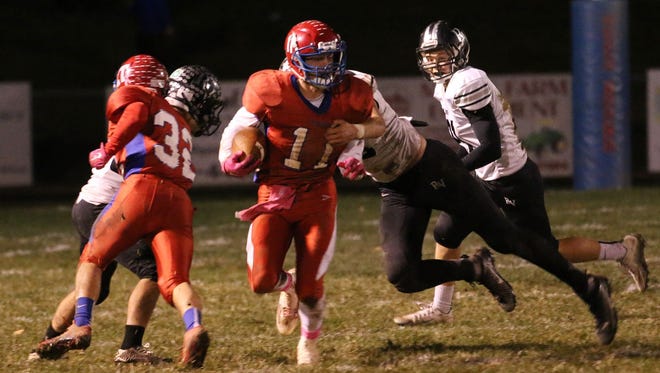 Zane Trace's Pierce Mowery carries the ball during a Div. V regional quarterfinal at Zane Trace High School on Nov. 6, 2015. Mowery helped the Pioneers finish 12-1 and reach, winning the first two playoff games in school history.