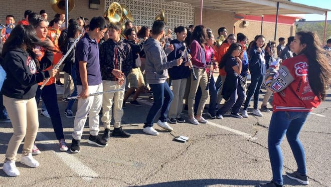 Henderson Middle School students on Monday morning await the arrival of their school's chess team, which won state championships this weekend.