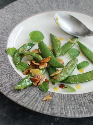 After a long winter of heavy foods, this simple, but delicious dish of minty sugar snap peas with tangerine and toasted almonds adds bright flavors and colors to springtime meals.
