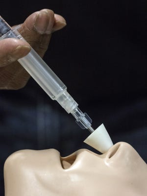 A CPR dummy is used to illustrate how an injection of Naloxone can be administered through the nasal passage when trying to revive a heroin overdose. 4/6/16