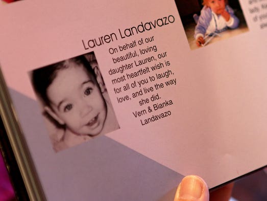 Bianka Landavazo reads the baby ad the family places