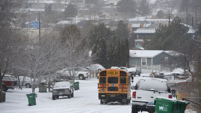 A WCSD bus drives through Sun Valley picking up kids for school on a snowy Thursday morning, Feb. 22, 2018.