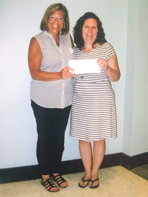 Shown from left is President Sue Zinck of  Anderson's Chapter L, P.E.O., and Robin Justice, grant recipient, at right.