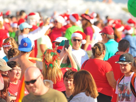 Thousands turned out to watch hundreds of surfing Santas