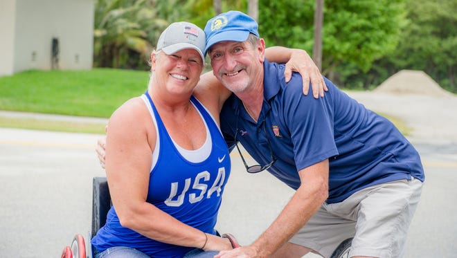 Harry Kapinowski, at right, bought Jacqui Kapinowski her first piece of adaptive equipment, began training her and they went to her first wheelchair marathon. “I was so scared," she said, "but I won the race and that qualified me for the Boston Marathon."