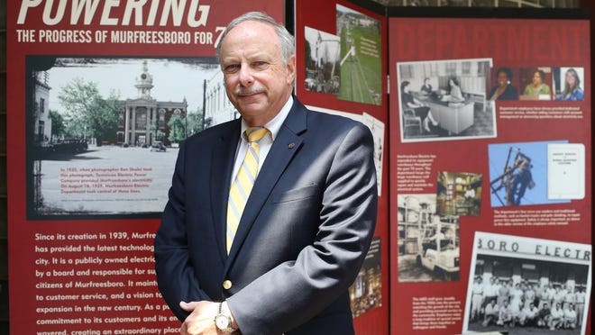 Steve Sax, former general manager of the Murfreesboro Electric stands in front of dieplay with information about the history of the Murfreesboro Electric Department.