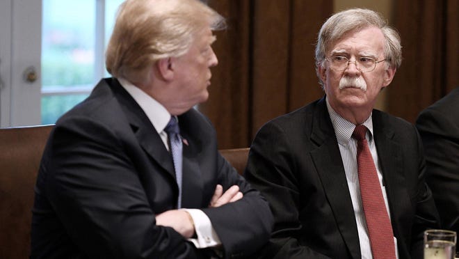 U.S. President Donald Trump, left, and John Bolton, right, national security adviser, attend a briefing from Senior Military Leadership in the Cabinet Room of the White House on April 9, 2018 in Washington, D.C. Trump fired Bolton Tuesday morning, announcing in a tweet that he\'d told him Monday night that "his services are no longer needed."