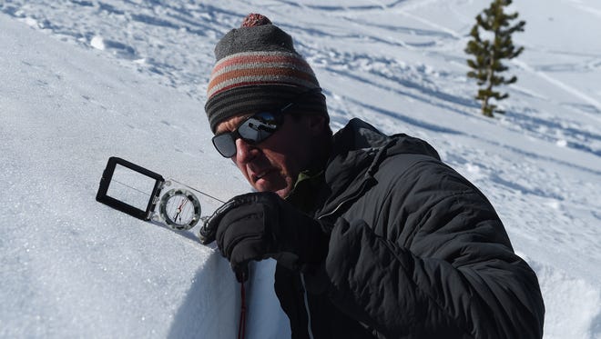 Owner of the Tahoe Mountain School and official observer for the Sierra Avalanche Center Steve Reynaud checks the exact degree of a northeast slope on Mount Tamarack near the top of Mt. Rose Highway south of Reno on Feb. 24, 2015.