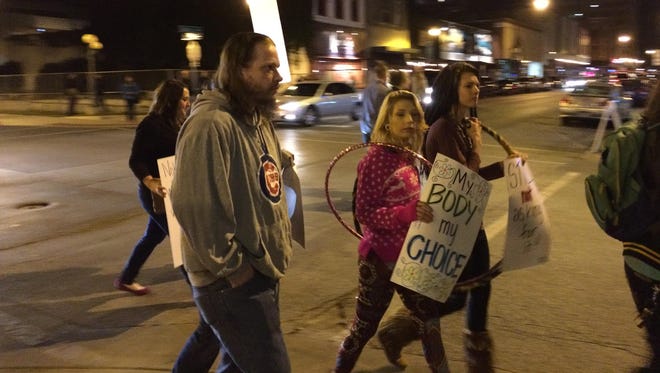 About 75 anti-rape protesters walked a four-block route in downtown Springfield for “SlutWalk 2015” Friday night.
