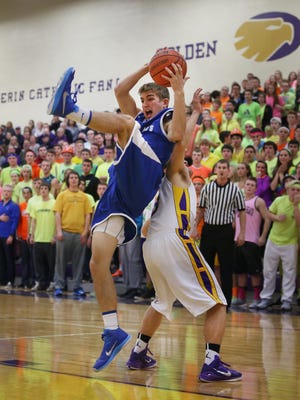 Bishop Chatard's Brooks Hepp comes down with the ball on top of Guerin Catholic High School's Cameron Lindley during Guerin's 73-50 win over the Trojans at Guerin in Noblesville on Friday, Jan. 9, 2015.