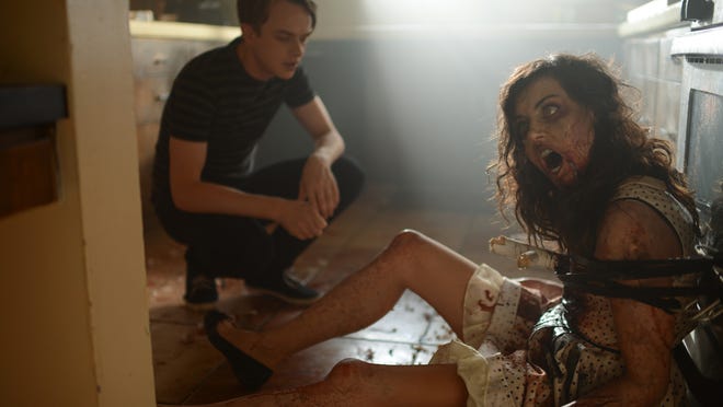 
Dane DeHaan (left) and Aubrey Plaza in a scene from the film "Life After Beth." 
