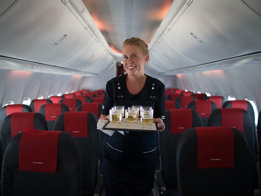 Cabin crew member Anna Ronnow serves champagne to passengers