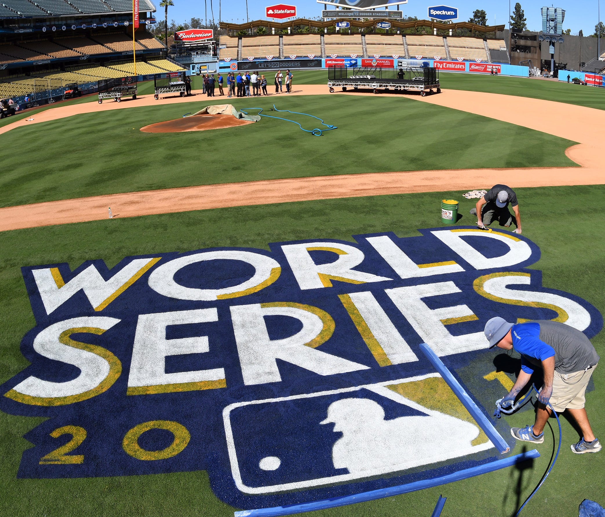 Oct. 23: Media Day/Workout at Dodger Stadium - Painters put the finishing touches on the World Series logo and the field before Monday's workouts at Dodger Stadium.