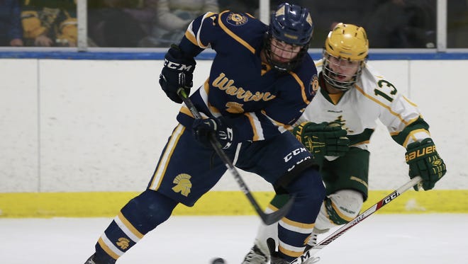 West's Max Zingler, left, and Everest's Brendan Hoover battle for the puck during Tuesday night's
WIAA Division I boys hockey sectional semi-final at Marathon County Ice Arena.