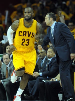 Cleveland Cavaliers forward LeBron James (23) is congratulated by head coach David Blatt after making a shot during the third quarter against the Atlanta Hawks in game four of the Eastern Conference Finals of the NBA Playoffs at Quicken Loans Arena.