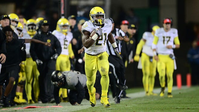 Oct 3, 2015; Boulder, CO, USA; Oregon Ducks running back Royce Freeman (21) carries after a pass reception in the second quarter against the Colorado Buffaloes at Folsom Field. Mandatory Credit: Ron Chenoy-USA TODAY Sports