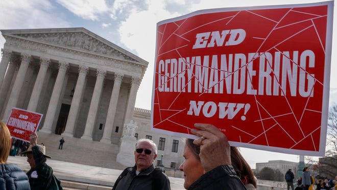 Demonstrators protest outside the Supreme Court in March as the justices heard the second of two challenges to partisan gerrymandering.
