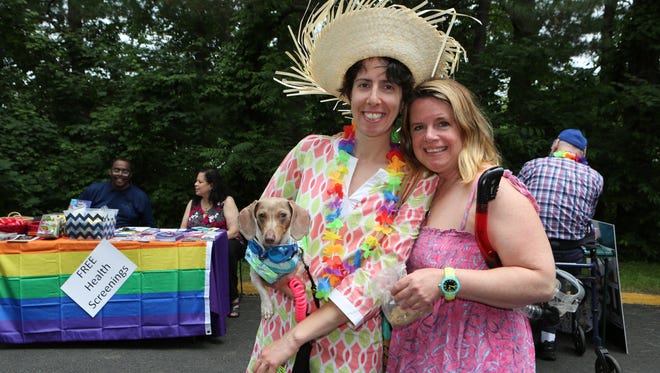 Dawn Eliott holding Capers and Sam Eliott from Stamford, Conn., pose for a photo during The LOFT LGBT Pride 2016 celebration at their community services center in White Plains, June 4, 2016.