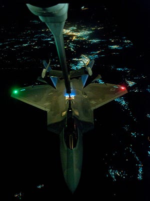 A U.S. fighter jet refuels prior to an airstrike against Islamic State groups in Sept, 2014. Obama quoted a 2001 authorization of force to deploy the airstrikes last year. That authorization must be repealed, critics say.