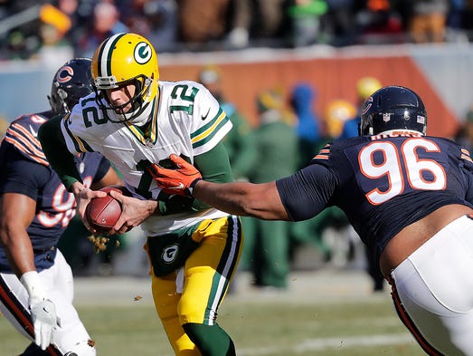 Green Bay Packers quarterback Aaron Rodgers (12) scrambles