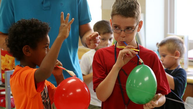 Isaiah Mead-Jackson counts down the start of a balloon race with Luke Helles Jr. at Soaring Stars held at Mount Morris Elementary School. The summer school program has helped children in rural areas keep on track academically.
