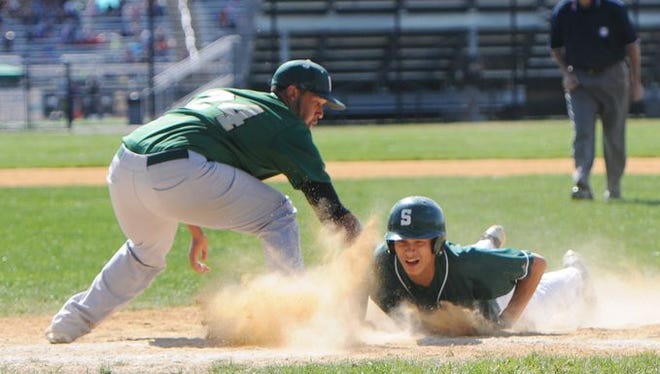 Spackenkill High School's Josh Rosario slides back to first base during a May 2, 2015 game against Franklin D. Roosevelt.
