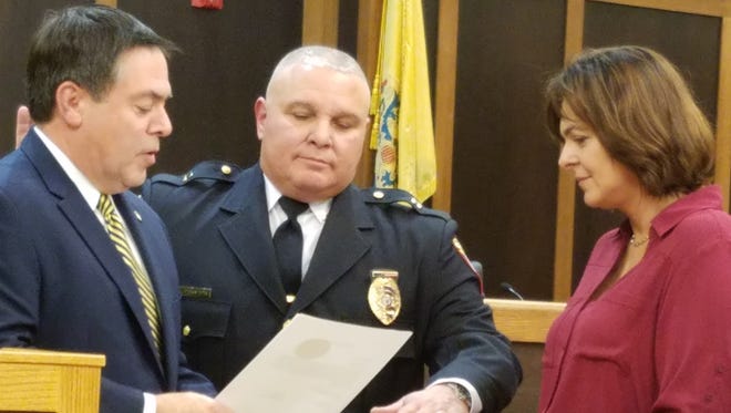 With his wife, Phyllis, holding the Bible, Al Nicaretta is sworn in Jan. 11 as Bridgewater's sixth police chief by Mayor Dan Hayes.