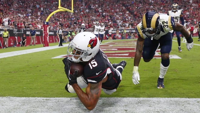 Arizona Cardinals wide receiver Michael Floyd (15) catches a pass for a touchdown against Los Angeles Rams cornerback Troy Hill (32) during the second quarter at University of Phoenix Stadium October 2, 2016. At halftime, Cardinals and Rams tied 10-10.