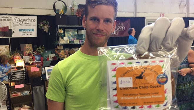 James Rolin displays Cowboy Cricket Farms' "chocolate chirp" cookie made  using cricket powder.