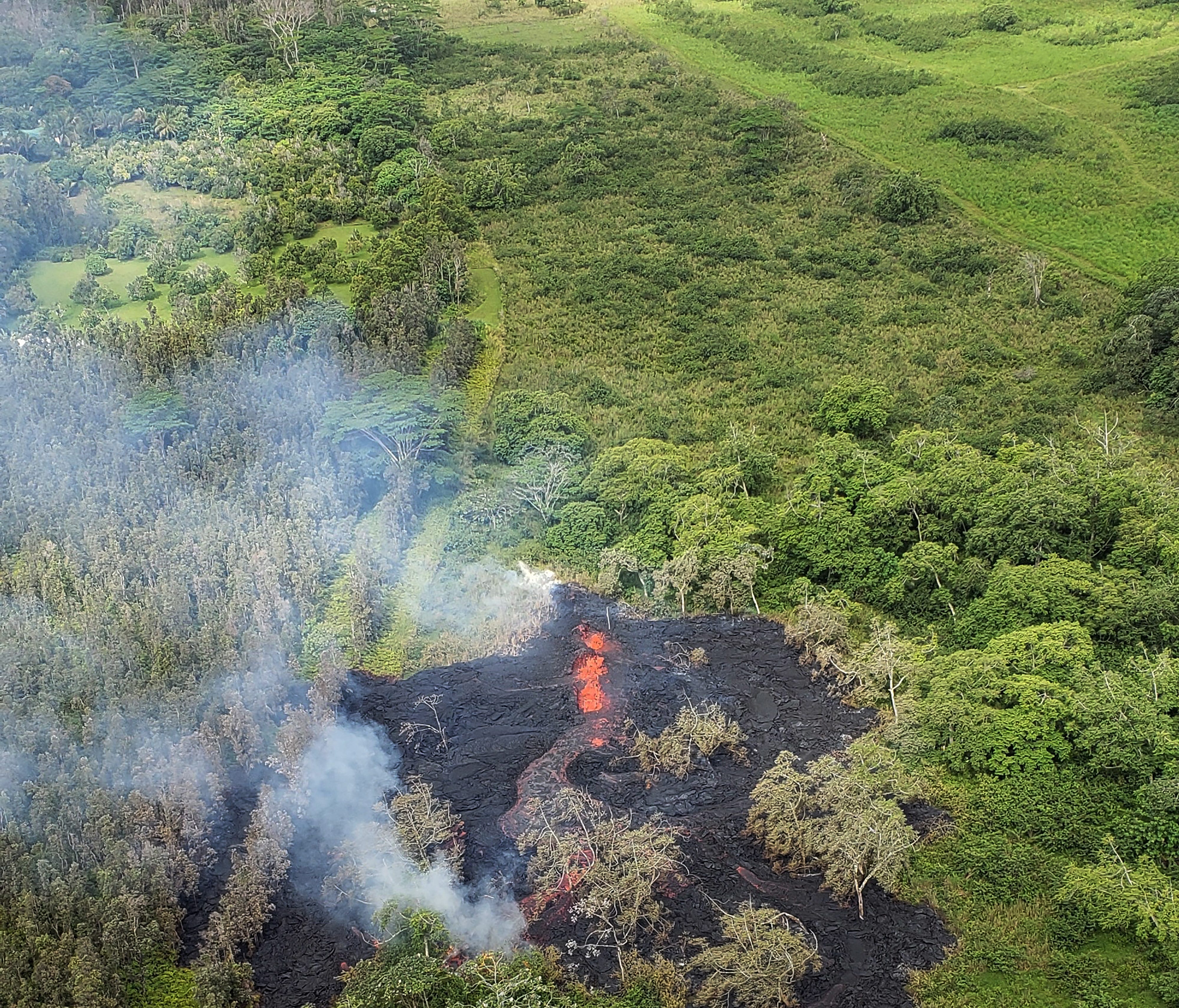 A handout photo made available by the Hawaii County Fire Department shows and aerial view of fissure 16 (bottom), located about 1.3 km northeast of fissure 15 (L, top), near Leilani Estate, Hawaii, USA,