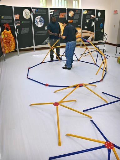  Delma Foster, left, and Pete Martinez assemble the