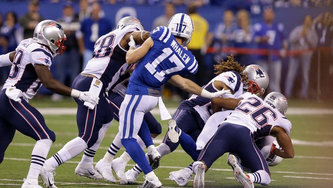 Indianapolis Colts wide receiver Griff Whalen (17) watches as Colts free safety Colt Anderson (32) is tackled by New England Patriots running back James White (28) on a fake punt in the second half of an NFL football game in Indianapolis.