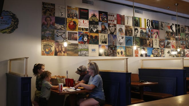 A family eats dinner at Starland Pizza in downtown on Saturday, May 23, 2020. The restaurant, like many in downtown Athens, has reopened with limited dining service following Gov. Brian Kemp's decision to end the state's shelter-at-home order despite COVID-19 cases continuing to grow in the state according to the Georgia Department of Public Health.