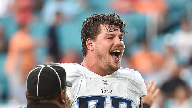 Sep 1, 2016; Miami Gardens, FL, USA; Tennessee Titans tackle Taylor Lewan (77) laughs at Miami Dolphins defensive end Andre Branch (50) during the first half against the at Hard Rock Stadium.