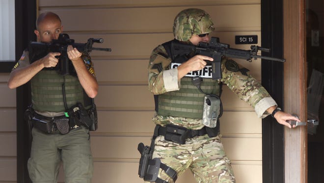 In this Oct. 1, 2015 file photo, authorities respond to a shooting at Umpqua Community College in Roseburg, Ore.  