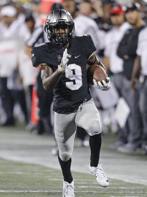 UCF running back Adrian Killins runs for a fourth quarter touchdown against the Florida International Golden Panthers on Sept. 24 in Miami.