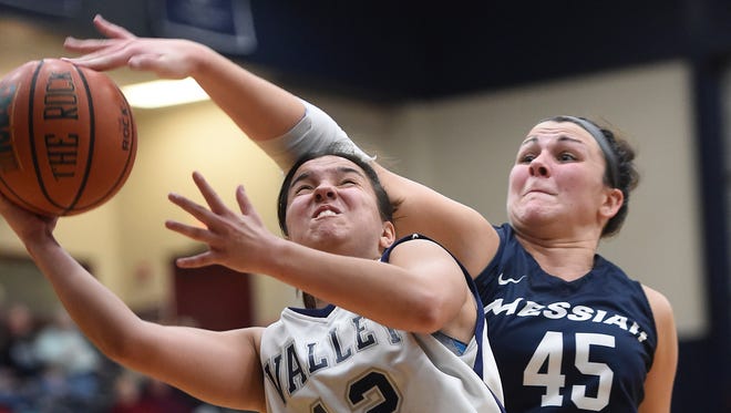 Lebanon Valley guard Kiely Chaklos (12) goes up for two but is fouled by Messiah's Gillian Glackin (45) late in Wednesday night's game. The Lebanon Valley  women squeaked past Messiah to win, 58-54.