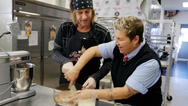 With the help of owner Kimmee Masi, Mark Weiss creates a dessert at Confections of a RockStar in Asbury Park.