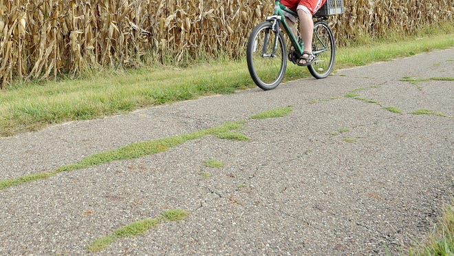A cyclist on the T.J. Evans Bike Trail in Newark between Sharon Valley Road and Goosepond Road near the Newark Area Soccer Association fields. The city of Newark and Licking Park District have reached an agreement to share the costs of improving the path.