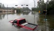 A flooded truck floats in floodwaters from Tropical