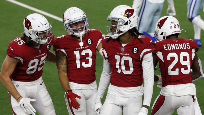 Arizona Cardinals Dan Arnold (85), Christian Kirk (13), DeAndre Hopkins (10) and Chase Edmonds (29) celebrate a long catch and run by Hopkins in the second half of the Cardinals' 38-10 win over the Dallas Cowboys in Arlington, Texas, Monday.